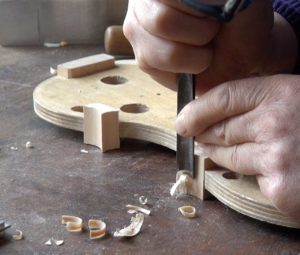 Cutting the corner block of a violin with a gouge