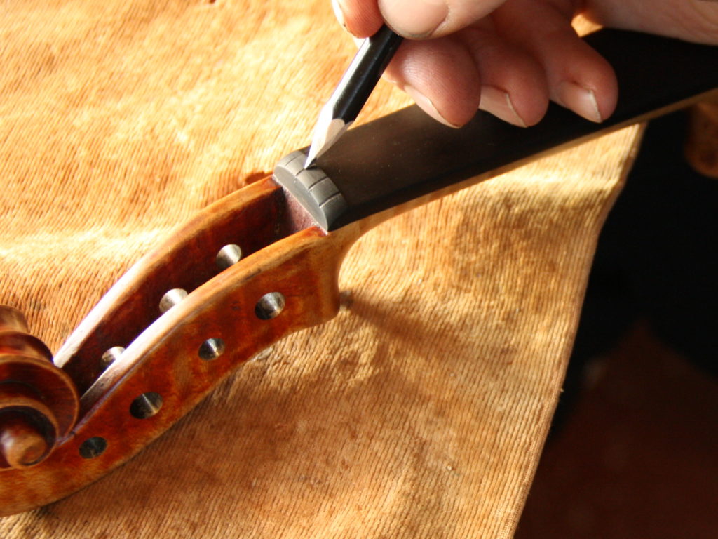 putting pencil lead in string groove of violin nut